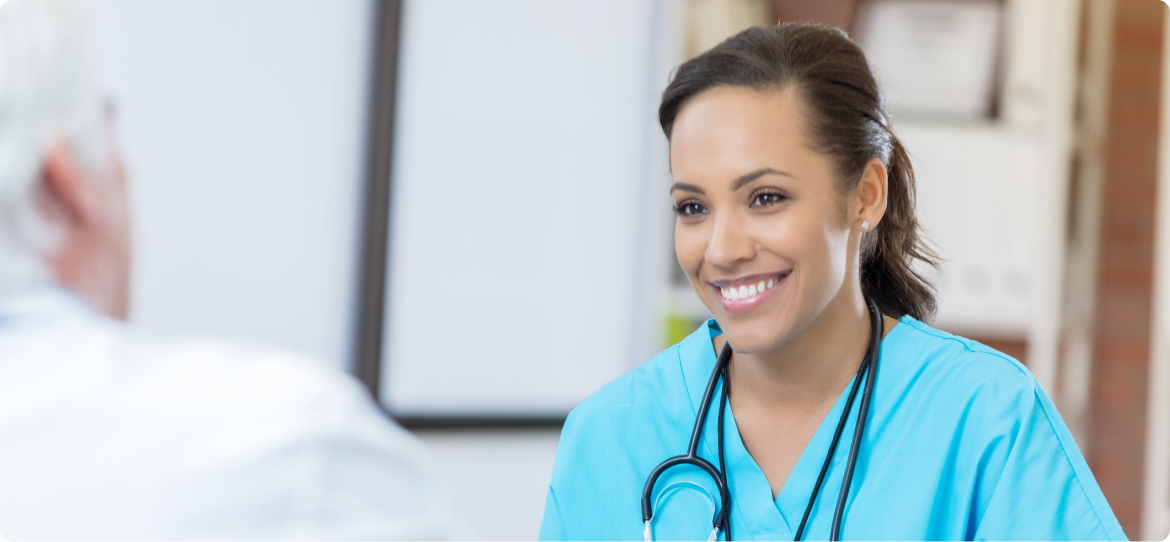 A female healthcare professional smiling at a patient