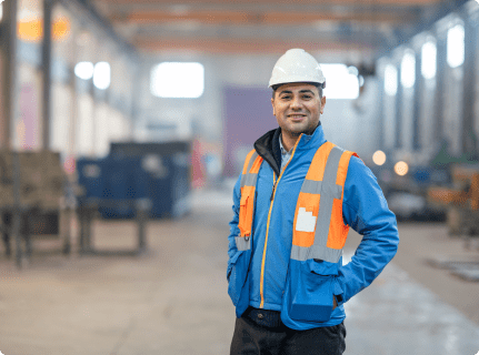 Man in hard hat standing in a large warehouse