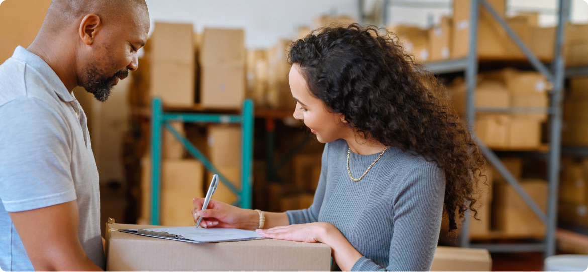 Woman signing for a package in a warehouse